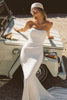 A woman wearing a strapless white mermaid style gown_XS_
