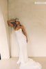 A woman wearing a strapless white wedding gown with a draped bodice and floor-length silhouette_xs_