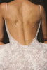 woman wearing a white lace backless dress with thin straps and delicate chain jewellery across her back_XS_