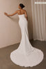 A woman wearing a strapless white wedding gown with a draped bodice and floor-length silhouette_xs_