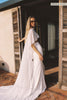 A woman models a sheer cape and a long wedding skirt_XS_