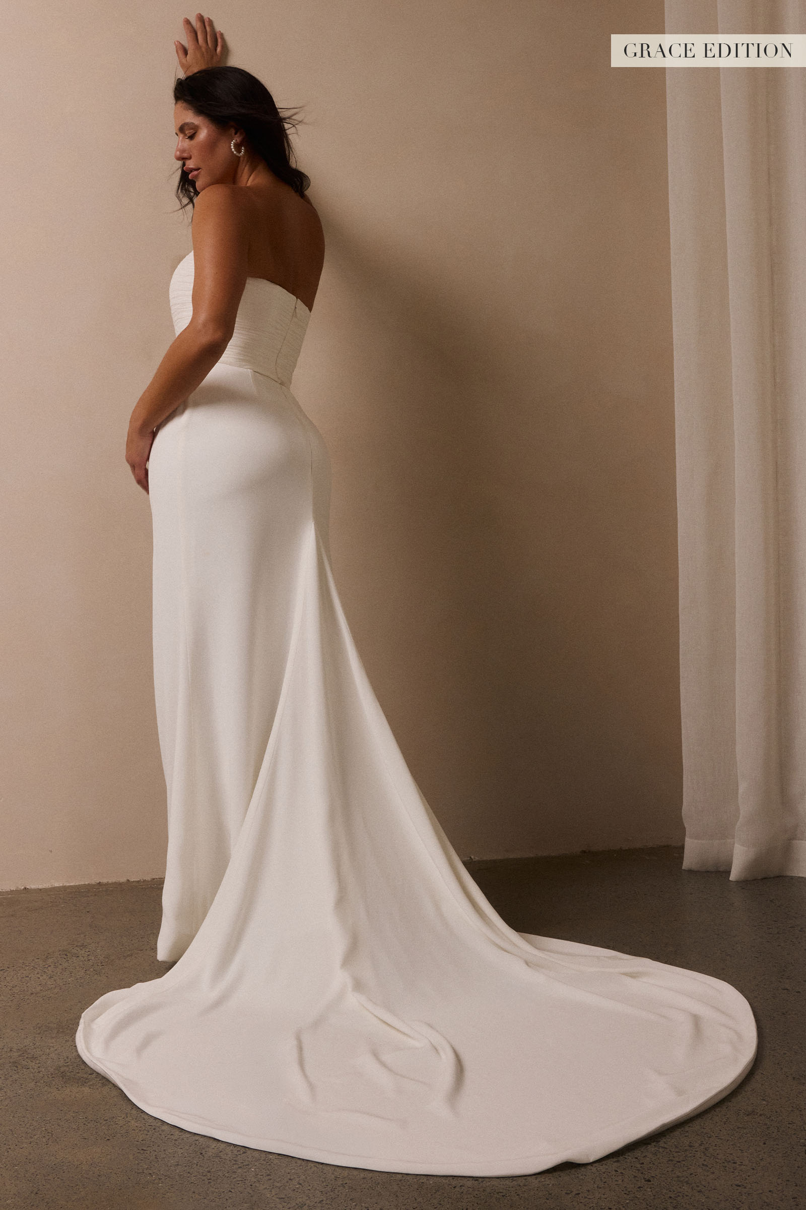 A woman models a structured corset and a long wedding skirt_L_