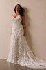 woman wearing a white lace backless dress with thin straps and delicate chain jewellery across her back_L_