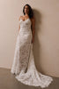 woman wearing a white lace backless dress with thin straps and delicate chain jewellery across her back_L_