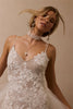 woman wearing a white lace backless dress with thin straps and delicate chain jewellery across her back_XS_
