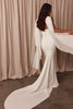 Woman in a white wedding dress with a white shawl