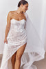 Woman wearing a lace wedding dress with a flowing veil_L_