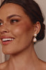 Woman wearing pearl earrings