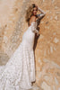 Woman in a lace wedding dress against a textured wall_XS_