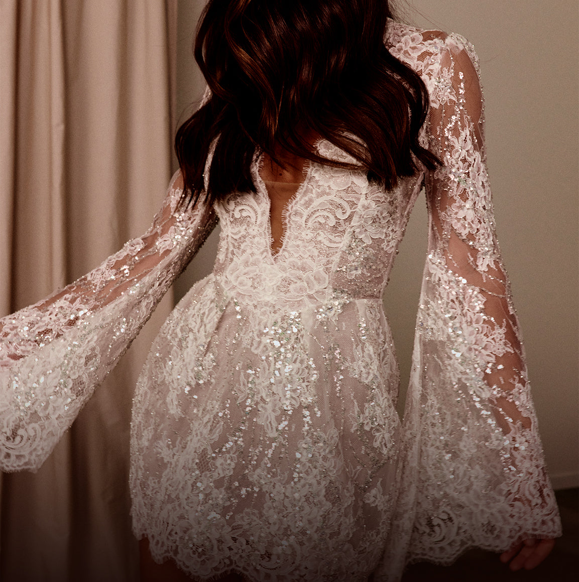 Short lace long sleeve wedding dress.
