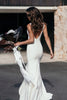 Back detailing of the Jones gown with model holding white bouquet