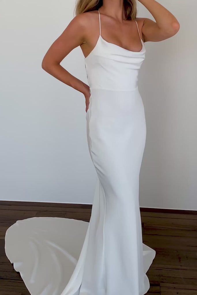 A woman wearing a silk spaghetti strap wedding dress.