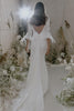 Back of Filamena gown on bride surrounded by floral arrangements